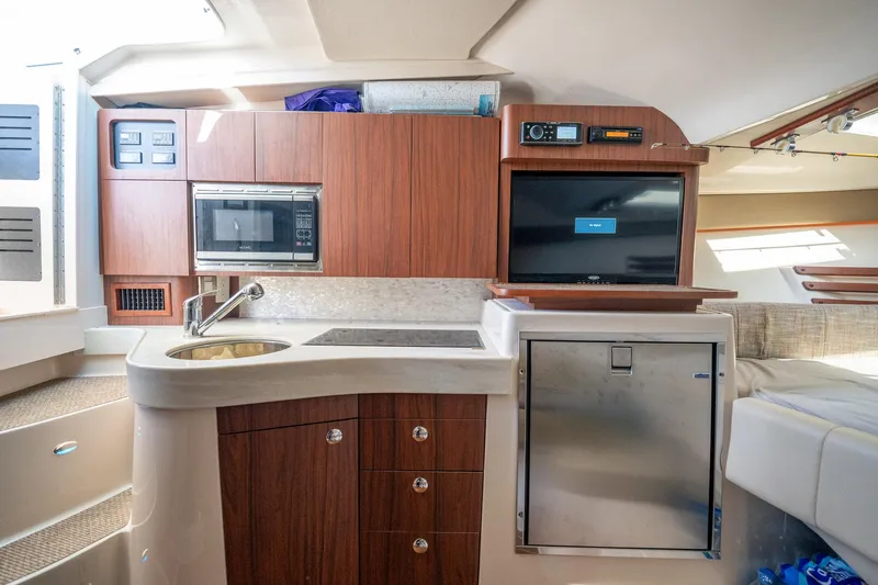 Meant To Be Yacht Photos Pics 2018 Grady-White Express 330 interior with kitchenette, microwave, and TV.