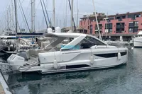 2024 Jeanneau DB/37 OB yacht docked in a marina, surrounded by other boats.
