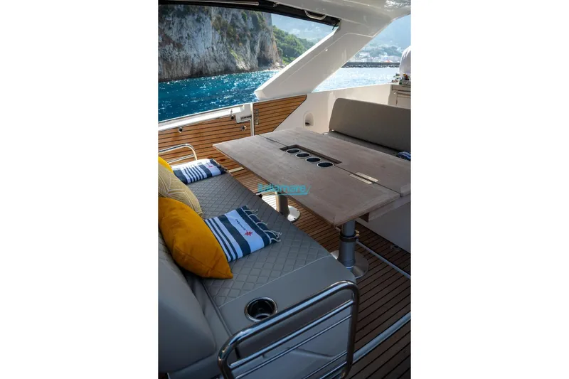  Yacht Photos Pics 2024 Jeanneau DB/37 OB yacht interior with elegant seating and scenic ocean view.