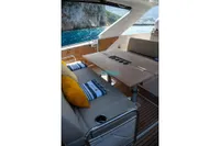 2024 Jeanneau DB/37 OB yacht interior with elegant seating and scenic ocean view.