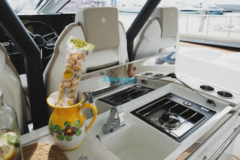  Yacht Photos Pics 2024 Jeanneau DB/37 OB boat interior with kitchen area and decorative pitcher.
