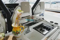 2024 Jeanneau DB/37 OB boat interior with kitchen area and decorative pitcher.