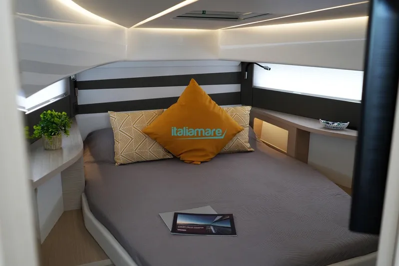  Yacht Photos Pics Luxurious cabin interior of 2024 Jeanneau DB/37 OB with modern decor and cozy bedding.