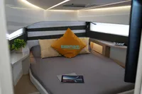 Luxurious cabin interior of 2024 Jeanneau DB/37 OB with modern decor and cozy bedding.