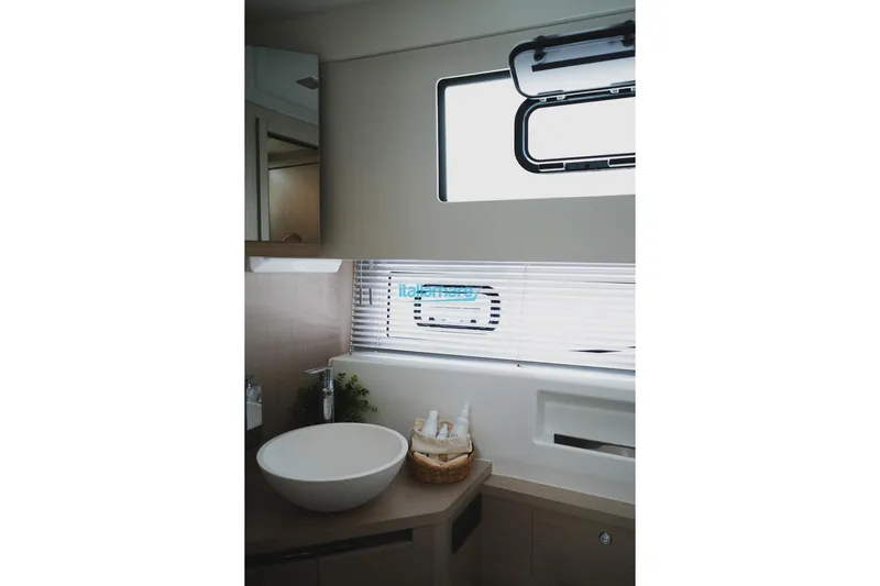  Yacht Photos Pics 2024 Jeanneau DB/37 OB yacht bathroom with modern sink and window.