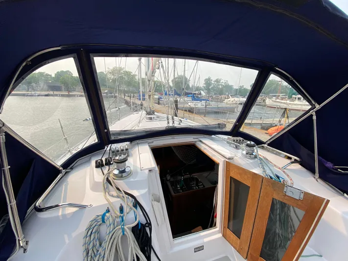  Yacht Photos Pics 2014 Catalina 355 sailboat cockpit with marina view, featuring ropes and wooden hatch.