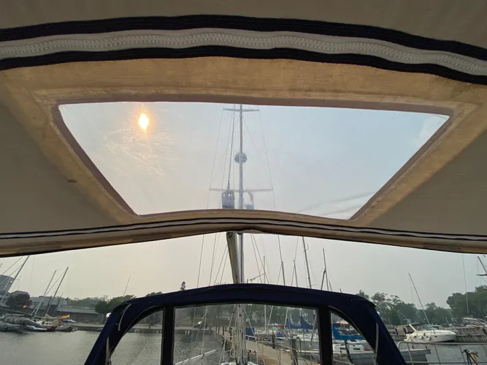  Yacht Photos Pics View from Catalina 355 sailboat cockpit, showcasing marina and mast through canopy window.