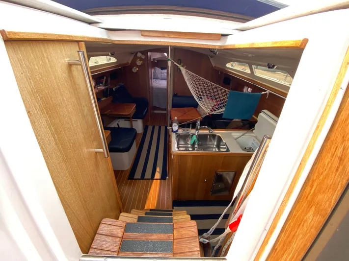  Yacht Photos Pics Interior of 2014 Catalina 355 sailboat with wood finish and compact kitchen area.