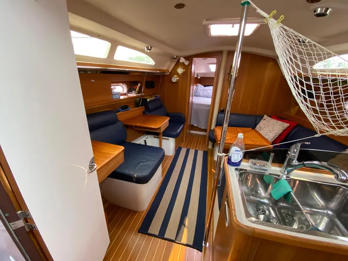 Yacht Photos Pics Interior of 2014 Catalina 355 sailboat with cozy seating and kitchenette.