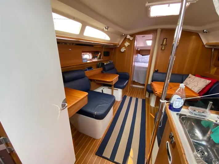 Yacht Photos Pics Interior of 2014 Catalina 355 sailboat with wood finish and blue seating.