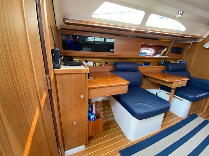  Yacht Photos Pics Interior of a 2014 Catalina 355 sailboat with wooden cabinetry and blue seating.