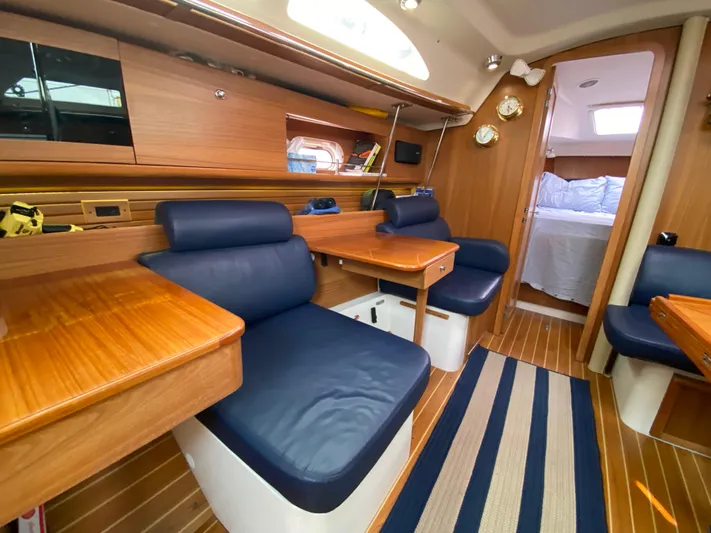  Yacht Photos Pics Interior of 2014 Catalina 355 sailboat with wooden furnishings and blue seating.
