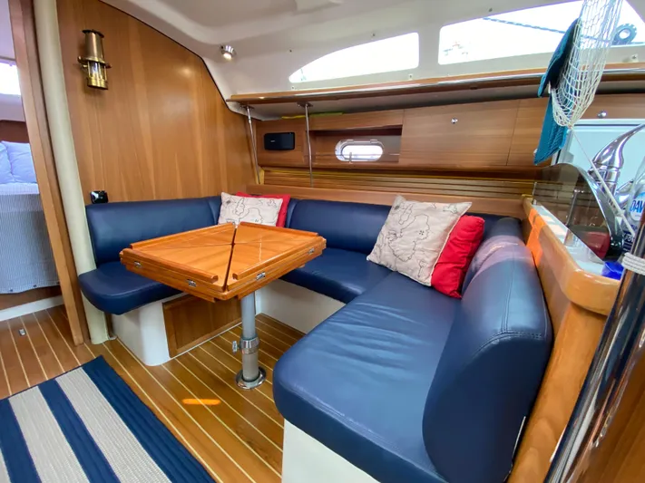  Yacht Photos Pics Interior of 2014 Catalina 355 yacht with blue seating and wooden table.