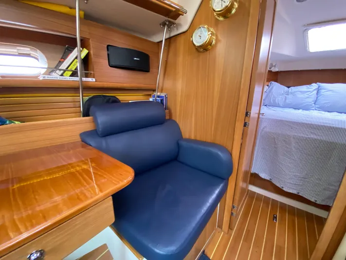  Yacht Photos Pics Interior of 2014 Catalina 355 sailboat with blue seating and wooden finishes.