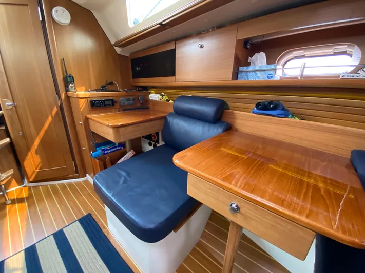  Yacht Photos Pics Interior of 2014 Catalina 355 sailboat with wooden furnishings and blue seating.
