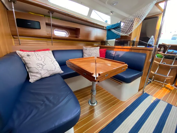  Yacht Photos Pics Interior of 2014 Catalina 355 sailboat with blue seating and wooden table.