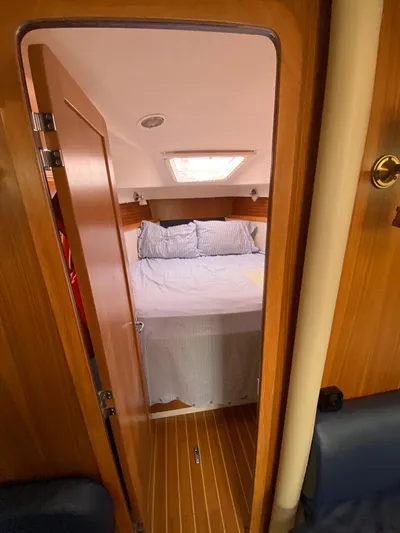  Yacht Photos Pics Catalina 355 yacht interior cabin with bed, wood paneling, and natural light, 2014 model.