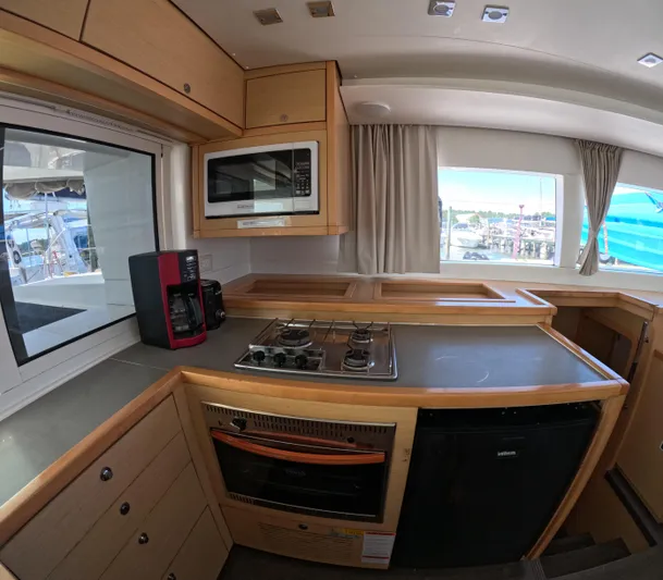 Halia Yacht Photos Pics Modern kitchen interior of 2014 Lagoon 450 yacht with appliances and window view.
