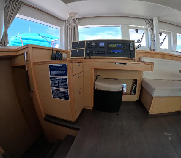 Halia Yacht Photos Pics Interior of a 2014 Lagoon 450 catamaran with navigation equipment and seating area.