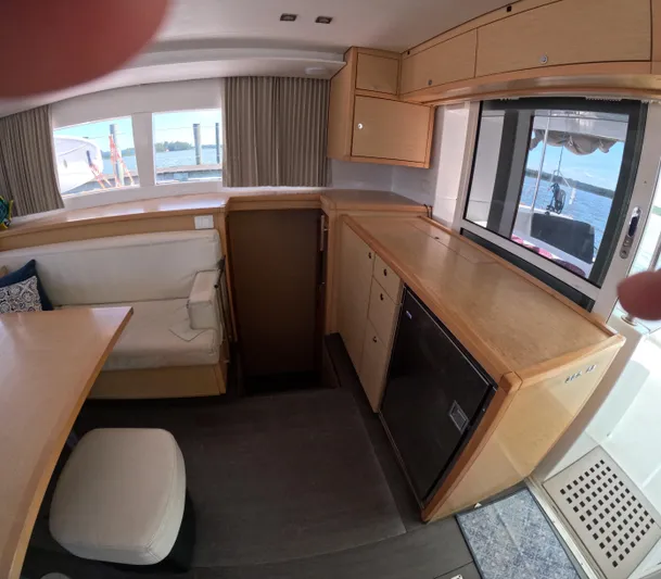 Halia Yacht Photos Pics Interior of 2014 Lagoon 450 catamaran with wooden cabinetry and seating area.