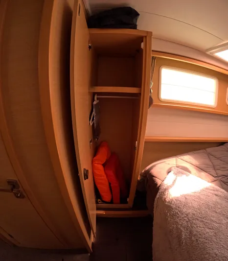Halia Yacht Photos Pics Interior of 2014 Lagoon 450 yacht cabin with wooden wardrobe and bed.