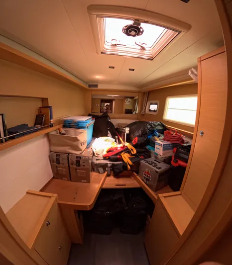 Halia Yacht Photos Pics Interior of a 2014 Lagoon 450 yacht cabin with storage boxes and equipment.