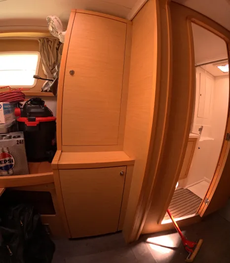 Halia Yacht Photos Pics Interior of 2014 Lagoon 450 yacht with wooden cabinets and adjacent bathroom.