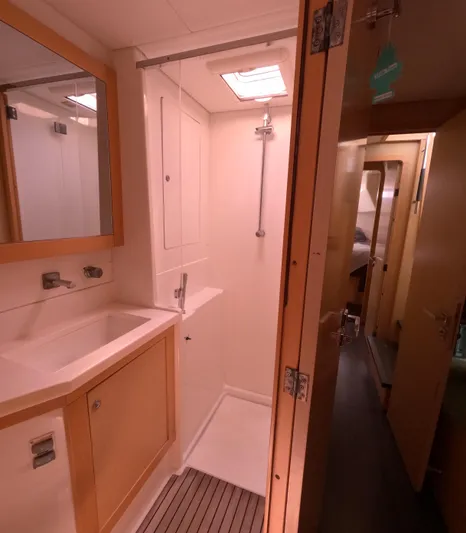 Halia Yacht Photos Pics 2014 Lagoon 450 yacht bathroom with shower, sink, and mirror.