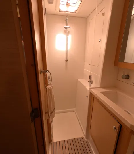 Halia Yacht Photos Pics Compact bathroom in a 2014 Lagoon 450 yacht, featuring a shower and sink.