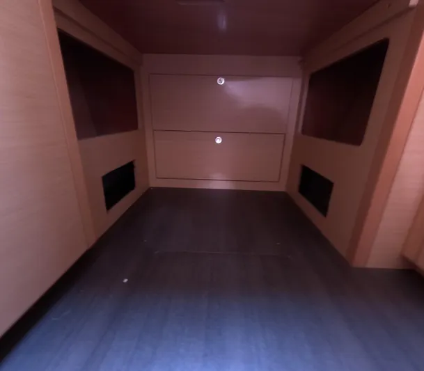 Halia Yacht Photos Pics Interior cabin storage of 2014 Lagoon 450 catamaran, featuring wooden drawers and shelves.
