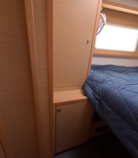 Halia Yacht Photos Pics 2014 Lagoon 450 cabin interior with bed and wooden cabinetry.