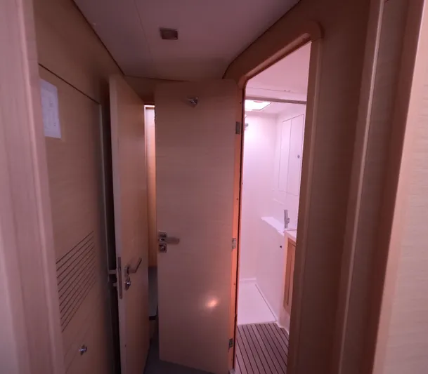 Halia Yacht Photos Pics Interior of 2014 Lagoon 450 yacht showing hallway and bathroom entrance.