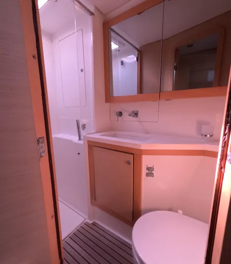 Halia Yacht Photos Pics 2014 Lagoon 450 yacht bathroom with modern fixtures and wooden accents.