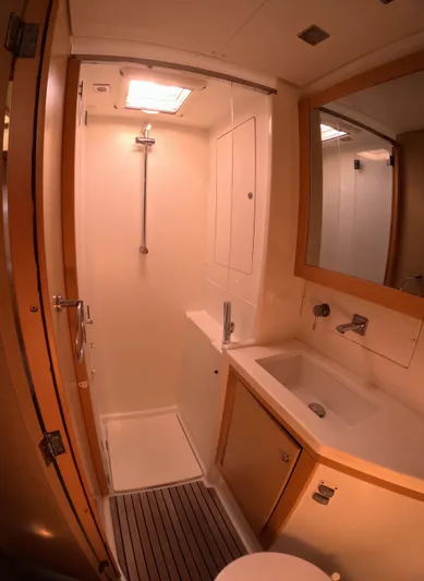 Halia Yacht Photos Pics 2014 Lagoon 450 yacht bathroom with shower, sink, and mirror.