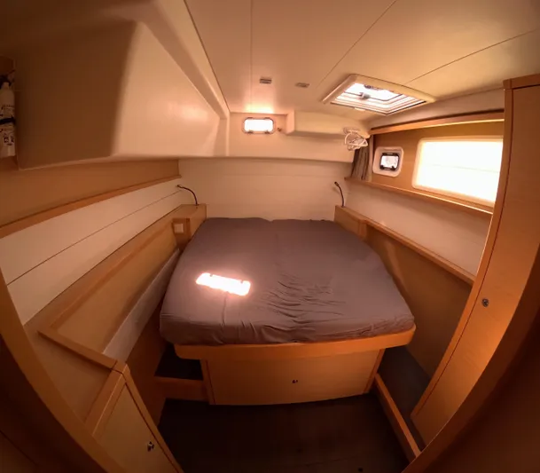 Halia Yacht Photos Pics Cozy cabin interior of 2014 Lagoon 450 catamaran with bed and wooden furnishings.