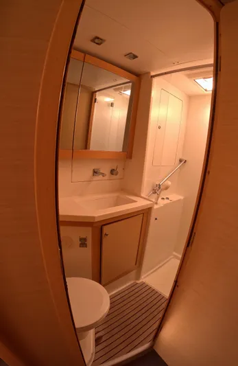 Halia Yacht Photos Pics 2014 Lagoon 450 yacht bathroom with modern fixtures and wooden accents.
