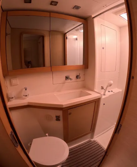 Halia Yacht Photos Pics 2014 Lagoon 450 yacht bathroom with modern fixtures and mirrored cabinets.