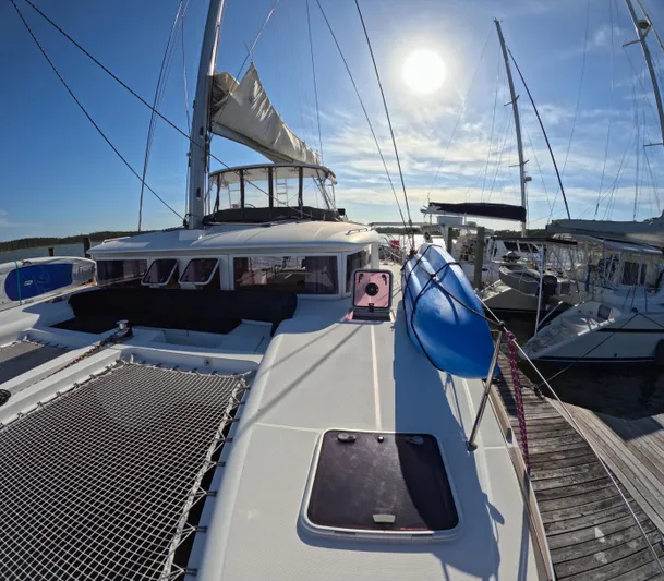 Halia Yacht Photos Pics 2014 Lagoon 450 catamaran docked under bright sun, featuring spacious deck and sails.