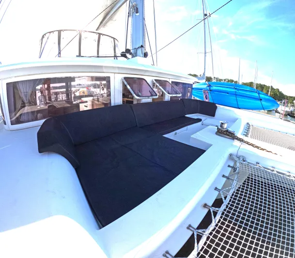 Halia Yacht Photos Pics 2014 Lagoon 450 catamaran with spacious deck and seating area, docked at marina.