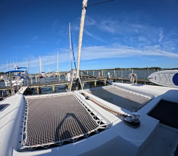 Halia Yacht Photos Pics 2014 Lagoon 450 catamaran docked at a marina under clear blue skies.