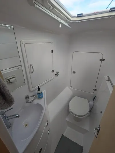 God Speed Yacht Photos Pics 2020 Seawind 1260 yacht bathroom with sink, toilet, and storage compartments.