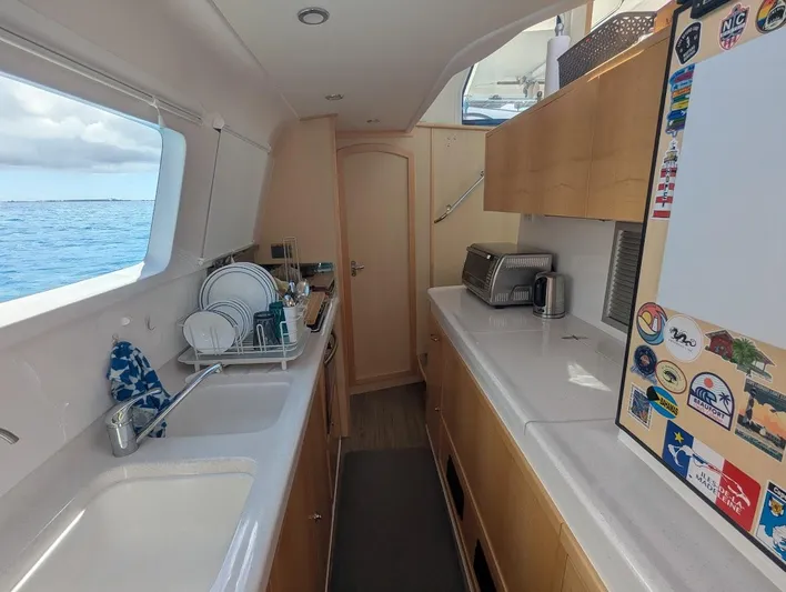 God Speed Yacht Photos Pics Interior of a 2020 Seawind 1260 catamaran kitchen with ocean view.