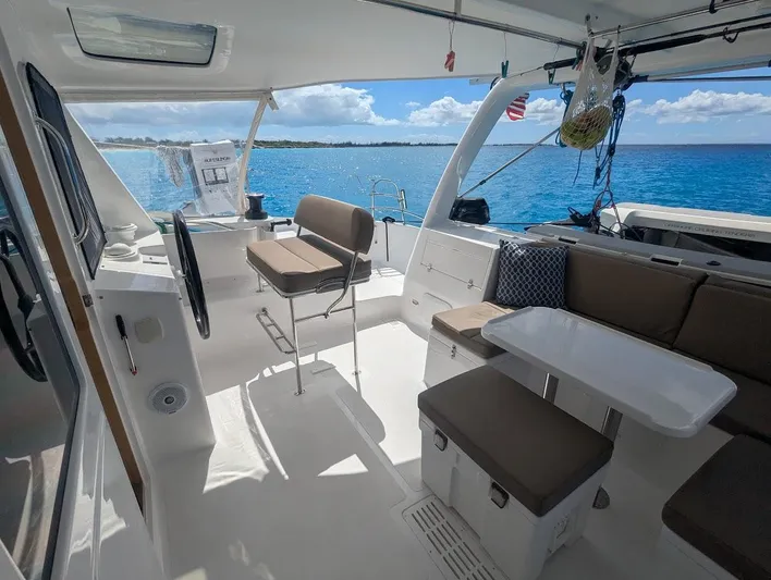 God Speed Yacht Photos Pics Interior of 2020 Seawind 1260 catamaran with seating, table, and ocean view.