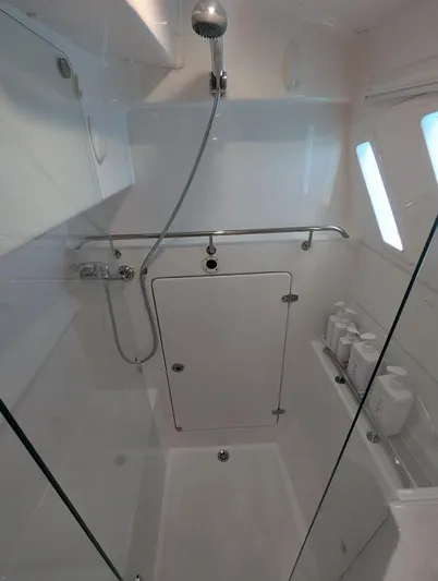 God Speed Yacht Photos Pics 2020 Seawind 1260 yacht shower with modern fixtures and storage shelves.