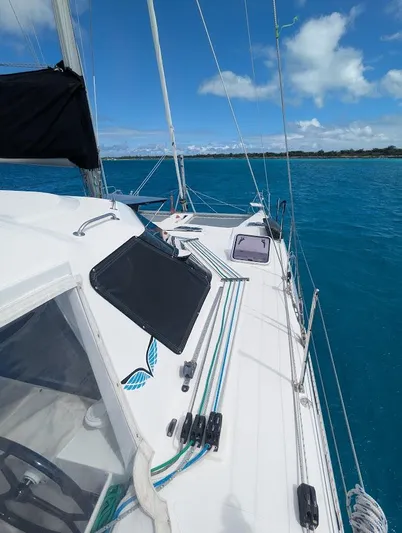 God Speed Yacht Photos Pics 2020 Seawind 1260 catamaran sailing on clear blue waters under a bright sky.