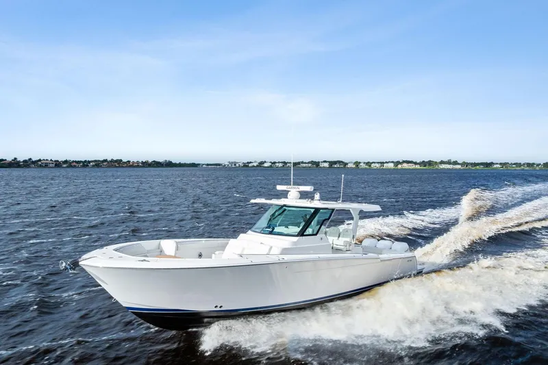 Isla Yacht Photos Pics 2022 Bertram 39 CC boat cruising on open water under clear blue sky.