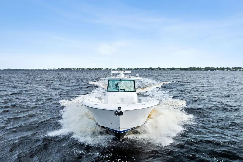 Isla Yacht Photos Pics 2022 Bertram 39 CC boat cruising on open water under clear blue sky.