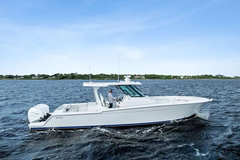 Isla Yacht Photos Pics 2022 Bertram 39 CC boat cruising on open water under clear blue sky.