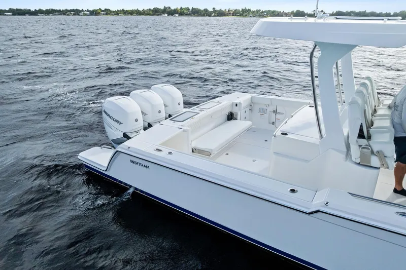 Isla Yacht Photos Pics 2022 Bertram 39 CC boat with triple Mercury engines on open water.