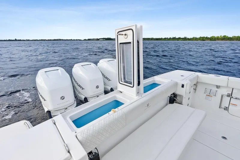 Isla Yacht Photos Pics 2022 Bertram 39 CC boat with triple Mercury outboard engines on open water.